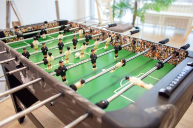 Playing table football in a bright room