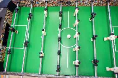 Big Game foosball top view. Playing table football in a bright room