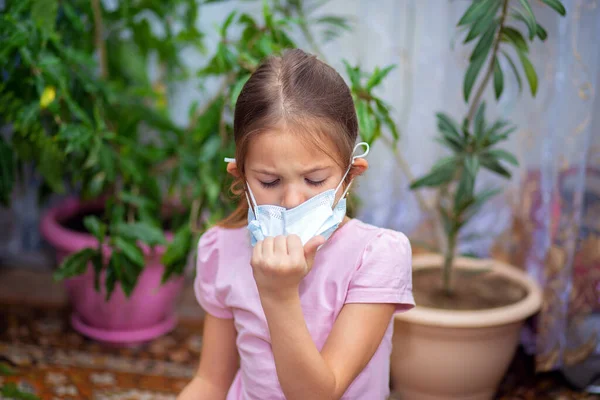 The girl pulls off a medical mask. Recovery, end of quarantine