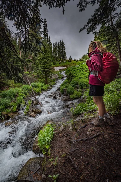 La yakınındaki basamaklı creek Colorado kız Backpacker hiking bakar — Stok fotoğraf