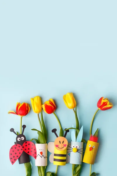 Happy easter kindergarten decoration concept - rabbit, chicken, egg, bee from toilet paper roll tube, fresh tulips. Simple diy. Eco-friendly reuse recycle decor, daycare paper craft