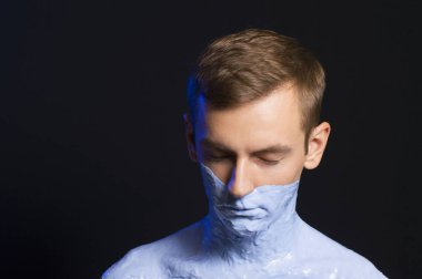 portrait of a guy body and part of the face in blue paint