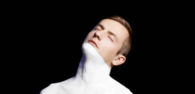 portrait of a guy body and part of the face in white paint
