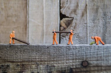 Endüstriyel sektörde çalışan minyatür şahsiyet - İnşaat işçilerinin elle işleme kavramını seçici bir odak ile kapatma.