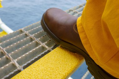 Close up of Industry steel staircase with yellow anti slip plate with safety shoe step on the tread. clipart