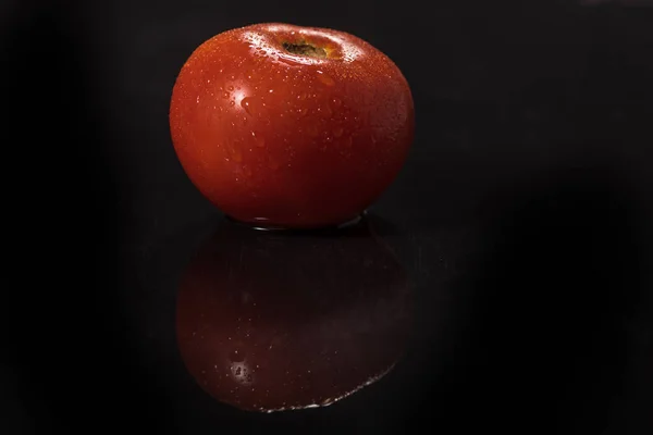 Tomatoes on black background ,water drops , mirror — Stock Photo, Image