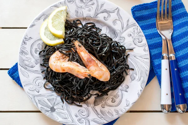 Shrimps with black seaweed and slices of lemon — Stock Photo, Image