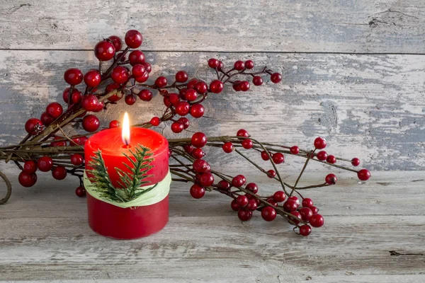 Lit candle and a stick of cranberries — Stock Photo, Image