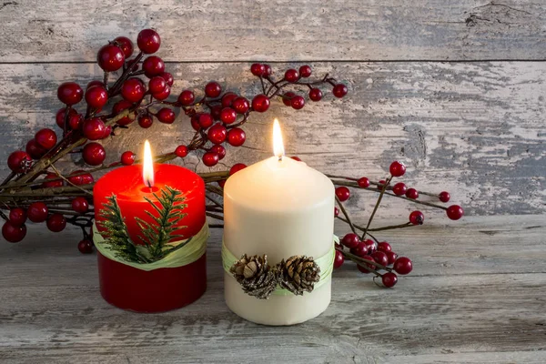 Lit candle and a stick of cranberries — Stock Photo, Image