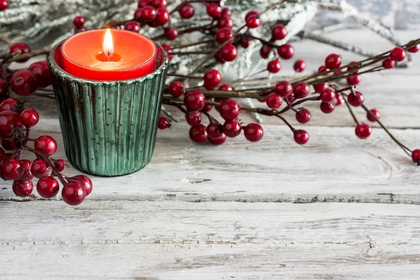 Candle and branch on wooden table — Stock Photo, Image