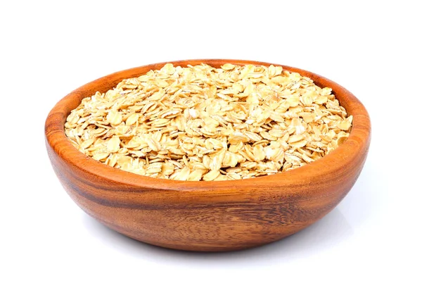 Copos de avena en un tazón de madera de cerca . — Foto de Stock