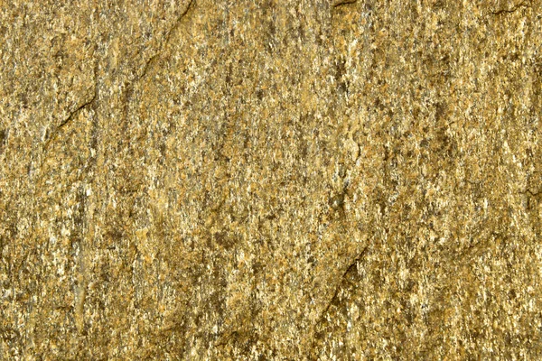 Фон з каменю з золотими плямами. Кам'яна скеля з золотими частинками . — стокове фото