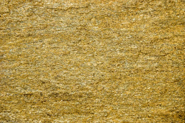 Фон з каменю з золотими плямами. Кам'яна скеля з золотими частинками . — стокове фото