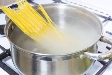 Bir gaz sobası üzerinde kaynar suda pişmiş spagetti.