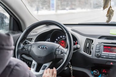 Belgorod, Russia-February 11, 2018: man driving a KIA. Photo steering the car close-up. clipart
