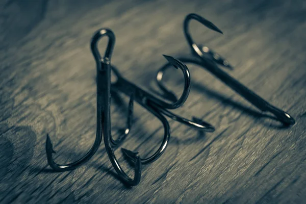 Sharp fish hooks photographed close-up. Sharpened hook will not give a chance to fish to escape from the fisherman.