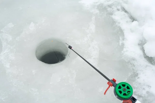 Fishing rod for winter fishing is on the ice. Wait for fish biting on winter fishing. — Stock Photo, Image