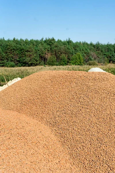 A lot of expanded clay in a pile on the construction site. — Stock Image A lot of expanded clay in a pile on the construction site. Stock Image
