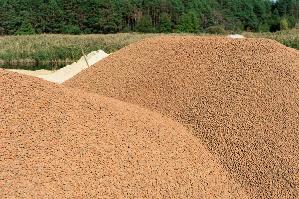 A lot of expanded clay in a pile on the construction site. — Stock Image Lot Expanded Clay Pile Construction Site Royalty Free Stock Images
