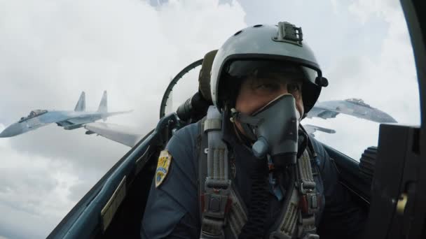 Close-up shot pilot in an aircraft cabin tear himself away from enemy aircraft. — Stock Video