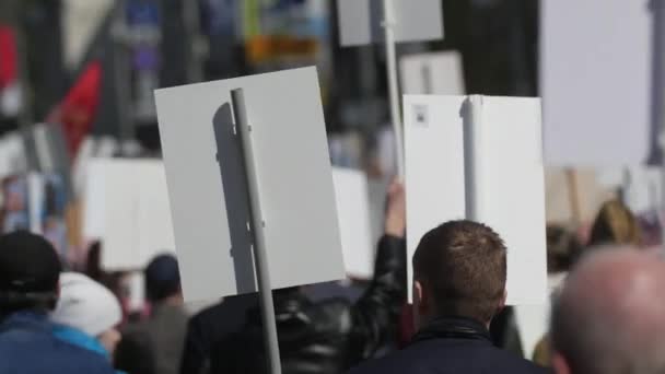 Crowd activists at a rally with posters are on the road walking banner Europe. — Stock Video