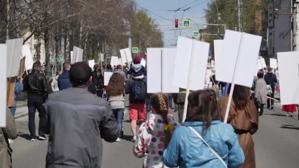 A crowd of activists go along with the children on strike on a city street 4K — Stock Video