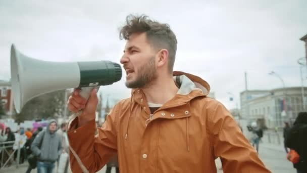 Man at political strike with megaphone shouting. Activist scream at loudspeaker. — ストック動画