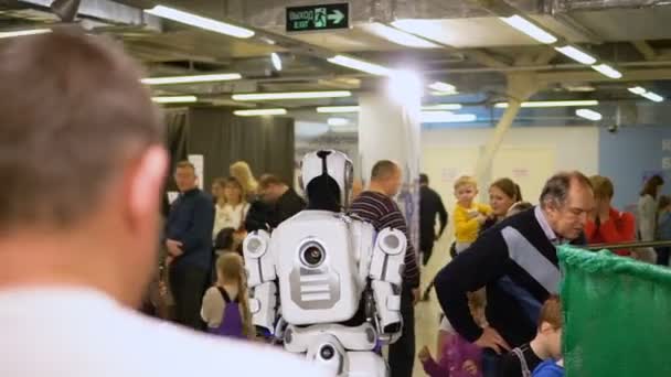 Cybernitization robot exhibition cyborg walk among people rally, demonstrate — Stock Video