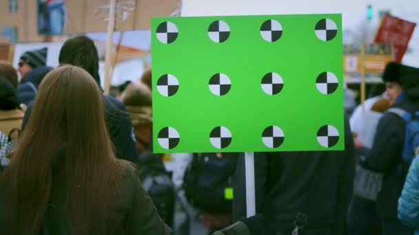 Banner in a crowd of people copy space text. Girl with a empty poster on strike. — Stock Video