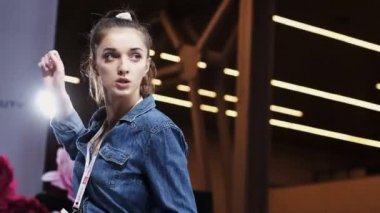 Attractive young woman gymnastic training hand close up cute movement on scene.