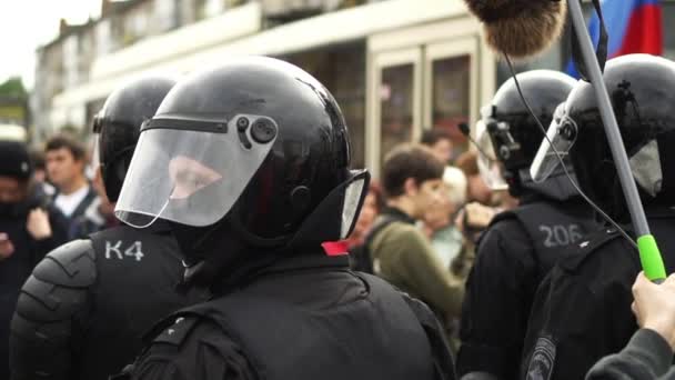 Helmet crowd armed policeman on street close up protect order. Strike people. — стокове відео
