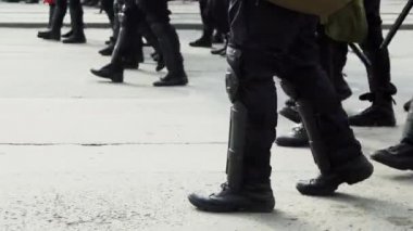March crowd officers special forces on street in helmet close up strike man 4K.