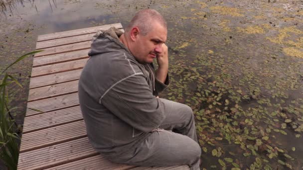 Uomo solitario con il fiore sul ponte pedonale — Video Stock