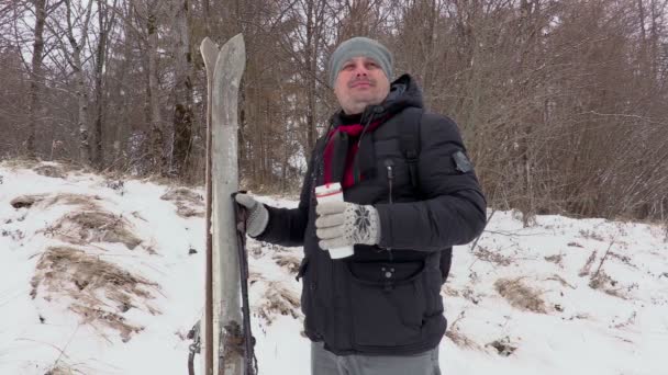 Mannen med par ski och termos på utomhus — Stockvideo