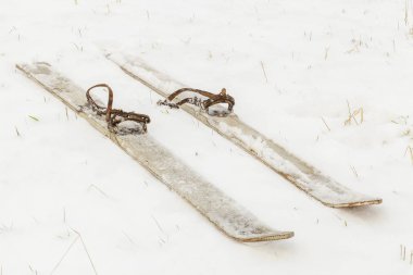 Pair of old skis on the snow  clipart