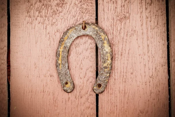 Horseshoe on wooden wall — Stock Photo, Image