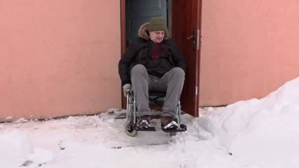 Disabled man on wheelchair talking near the door — Stock Video