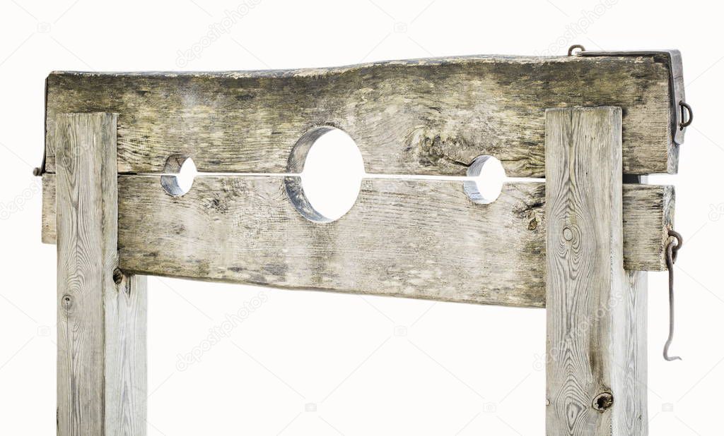 Wooden medieval pillory on white 
