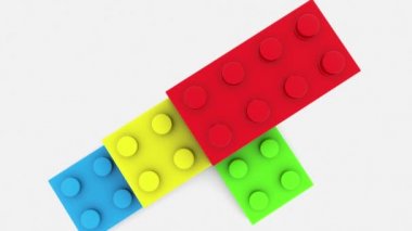 Beyaz üzerine çeşitli renklerde yığılmış oyuncak tuğla