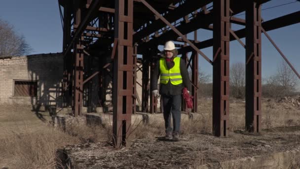 Zaměstnanci hovoří a procházky v blízkosti kovových nádrží — Stock video