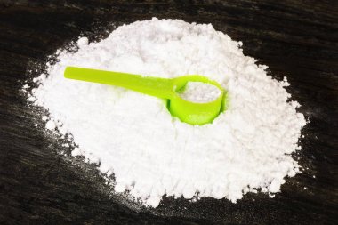 Creatine scoop on creatine monohydrate  clipart