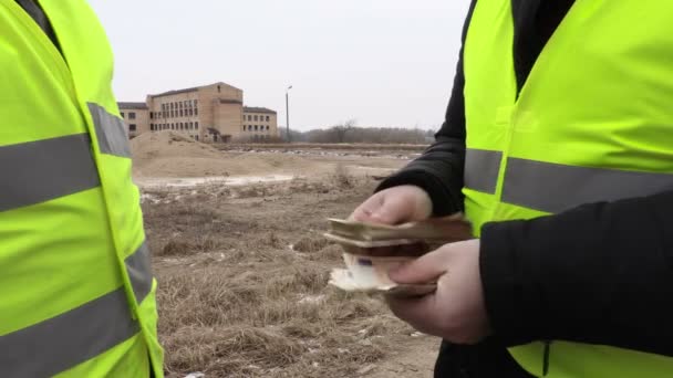 Aannemer geven eurobankbiljetten aan de bouwvakker — Stockvideo
