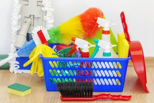 Cleaning equipment in basket with mop behind