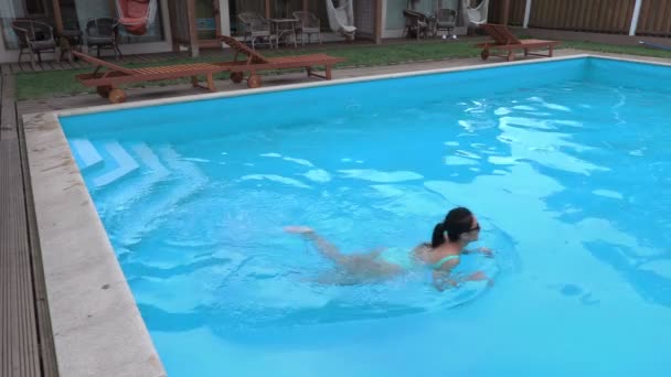 Frau schwimmt im Pool — Stockvideo