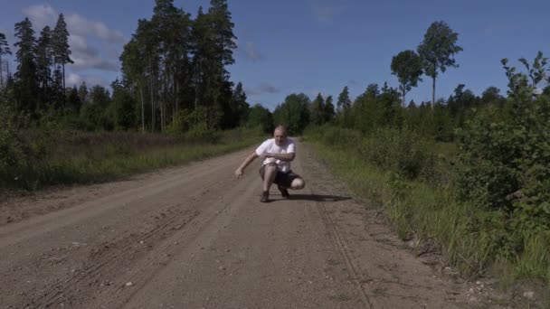 El hombre ejercita sus piernas después de correr — Vídeo de stock