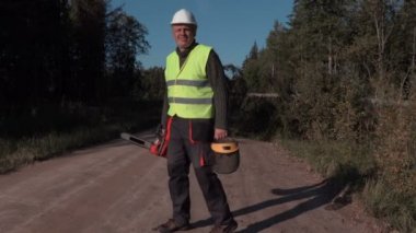 Orman işçisi yolda kırık ve düşmüş Ladin yakınındaki