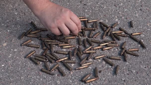 Man sorting used bullet shells — Stock Video