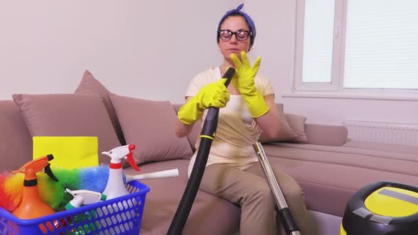 Woman Sitting Sofa Checking Vacuum Cleaner — Stock Video