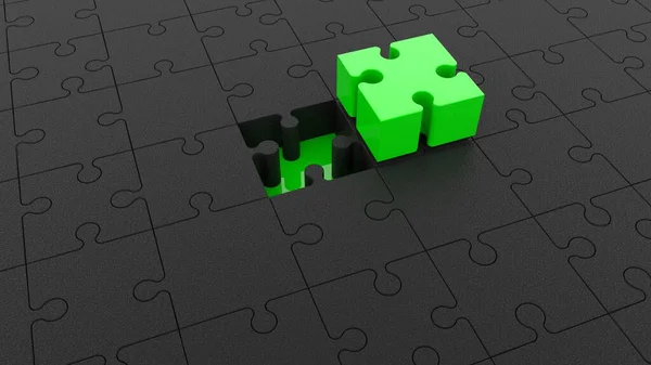 Textured black puzzle with green one in middle