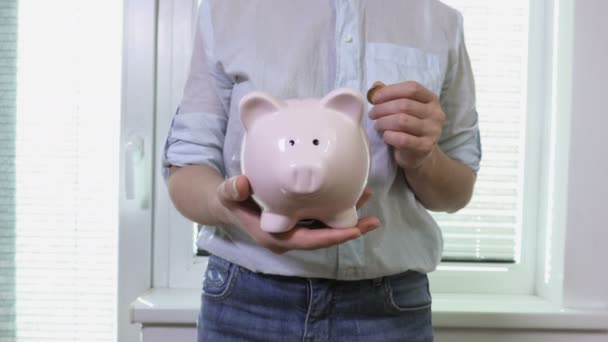 Woman Holding Pink Piggy Bank — Stock Video